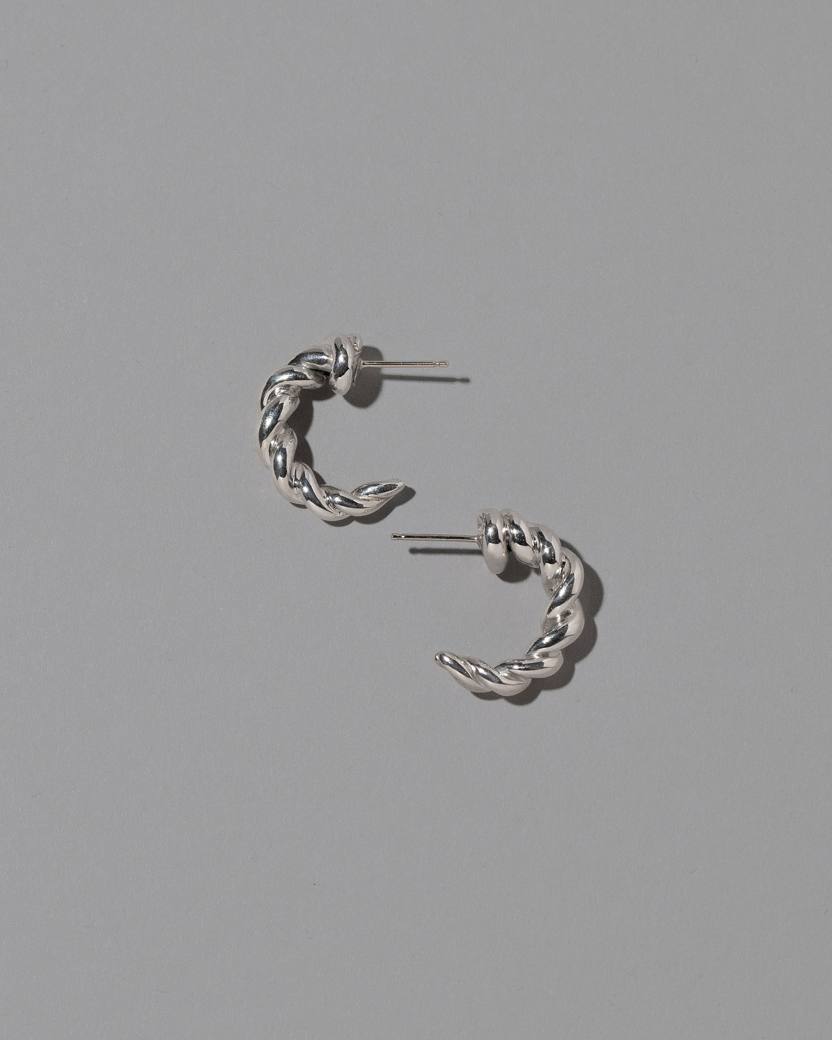 CRZM Sterling Silver Foothill Hoop Earrings on light color background.