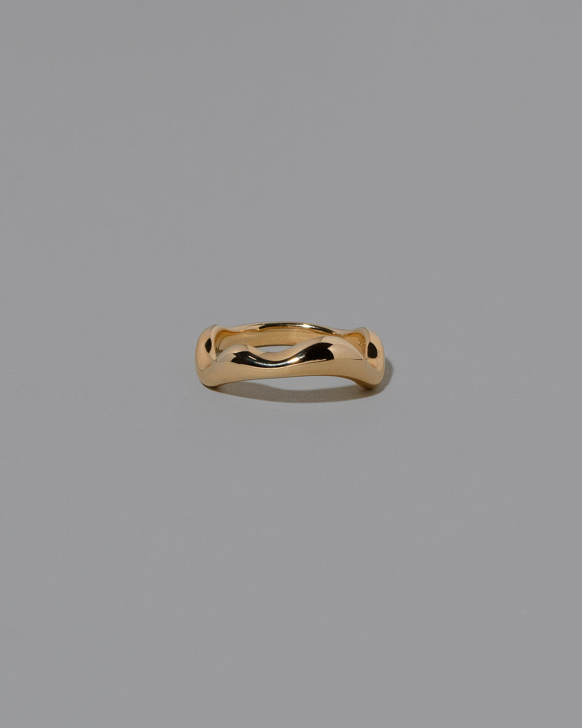 Gold Wide Fluctuating Band on light color background.