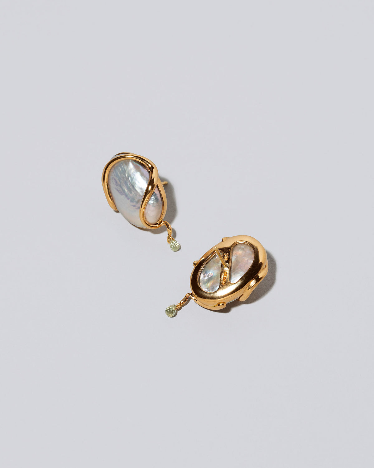 View from the back of the Weaver Earrings on light color background.