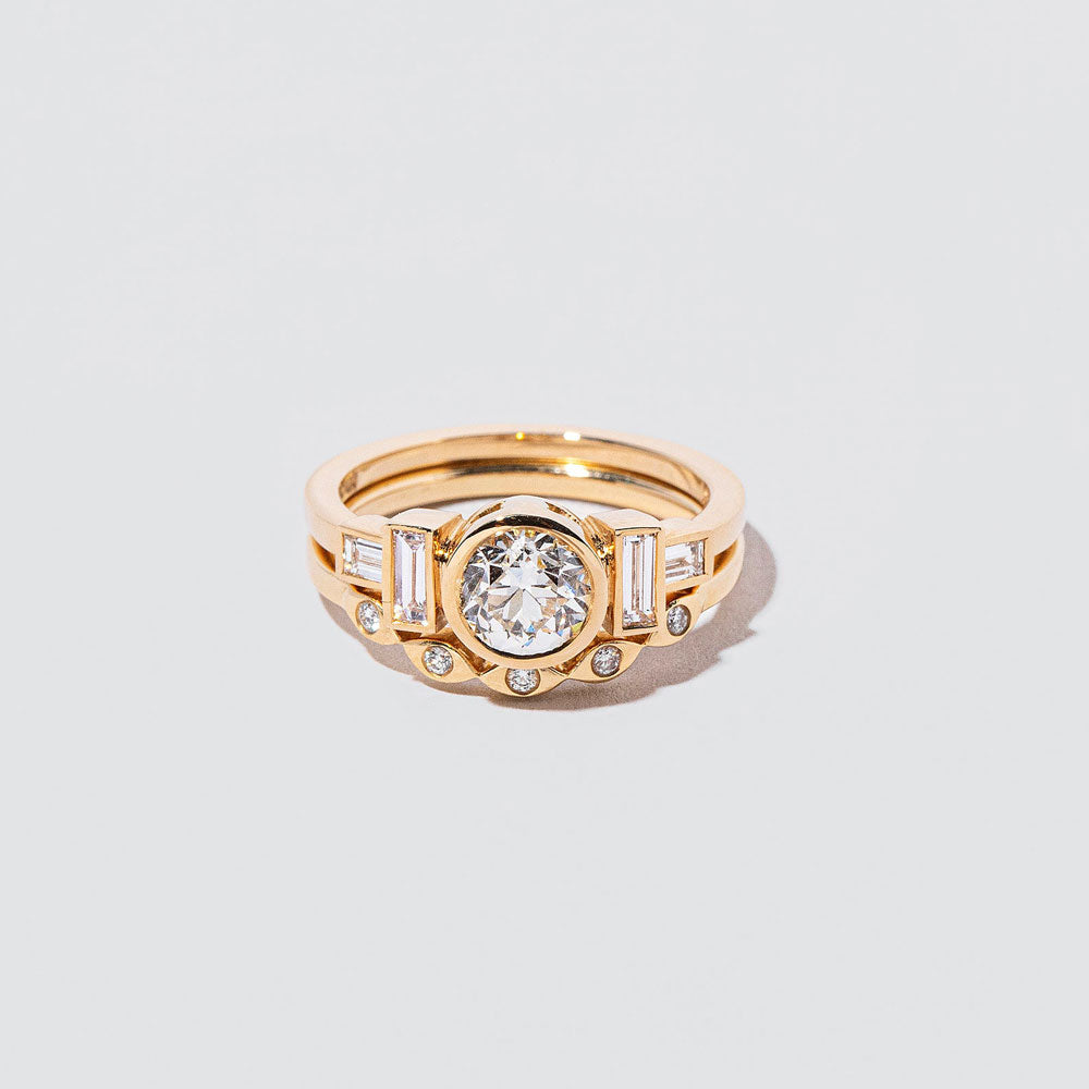 product_details::Gold Seeing Eye Band and Diamond Third Eye Ring on light color background.