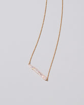 Stick Pearl Necklace on light color background.