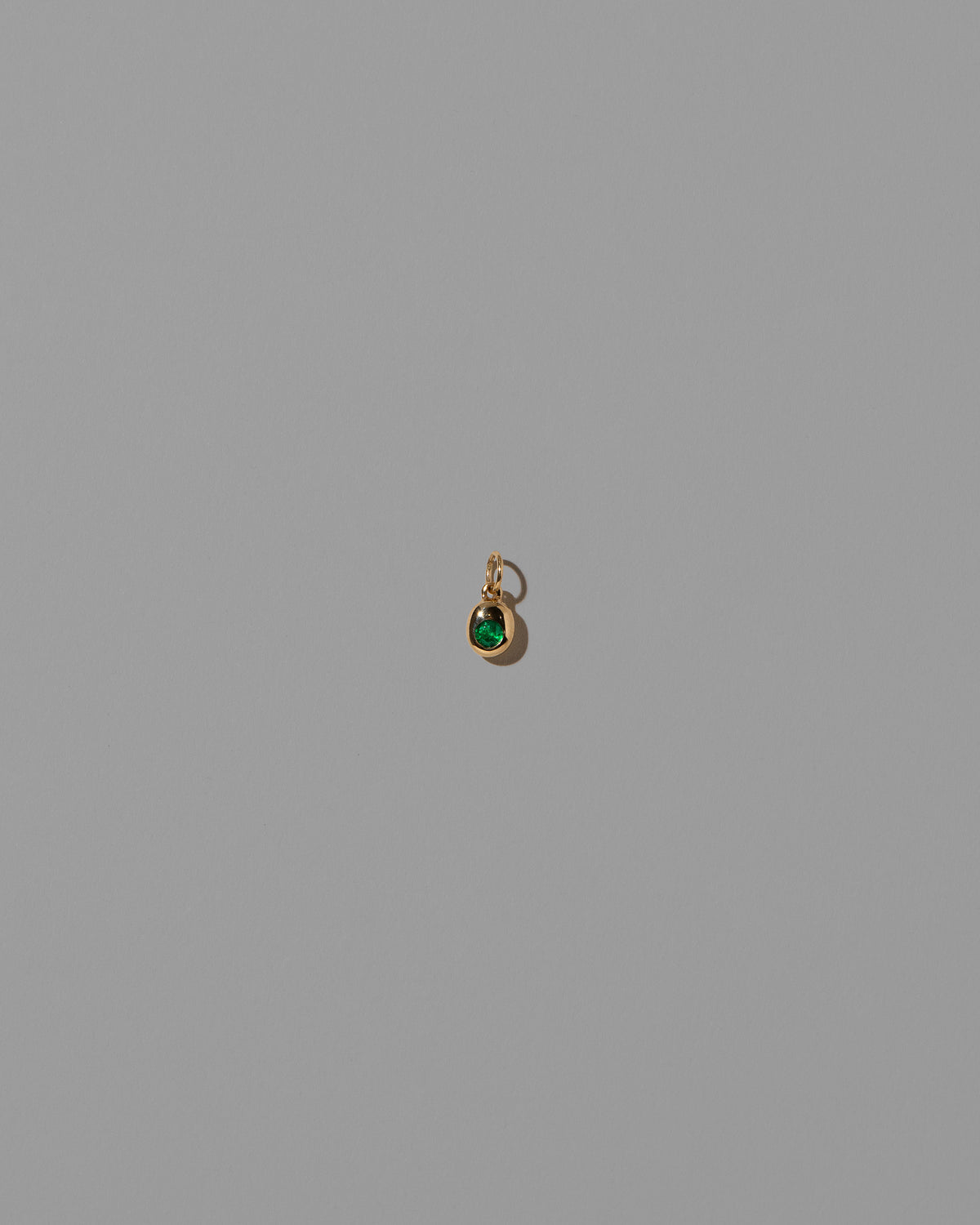 Emerald Birthstone Level Charm on light color background.