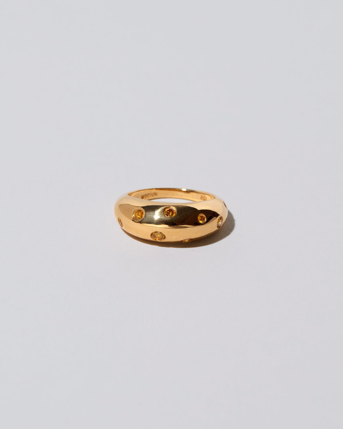 Gold Yellow Diamond Brilliant Cuts Light Cutter Band on light color background.