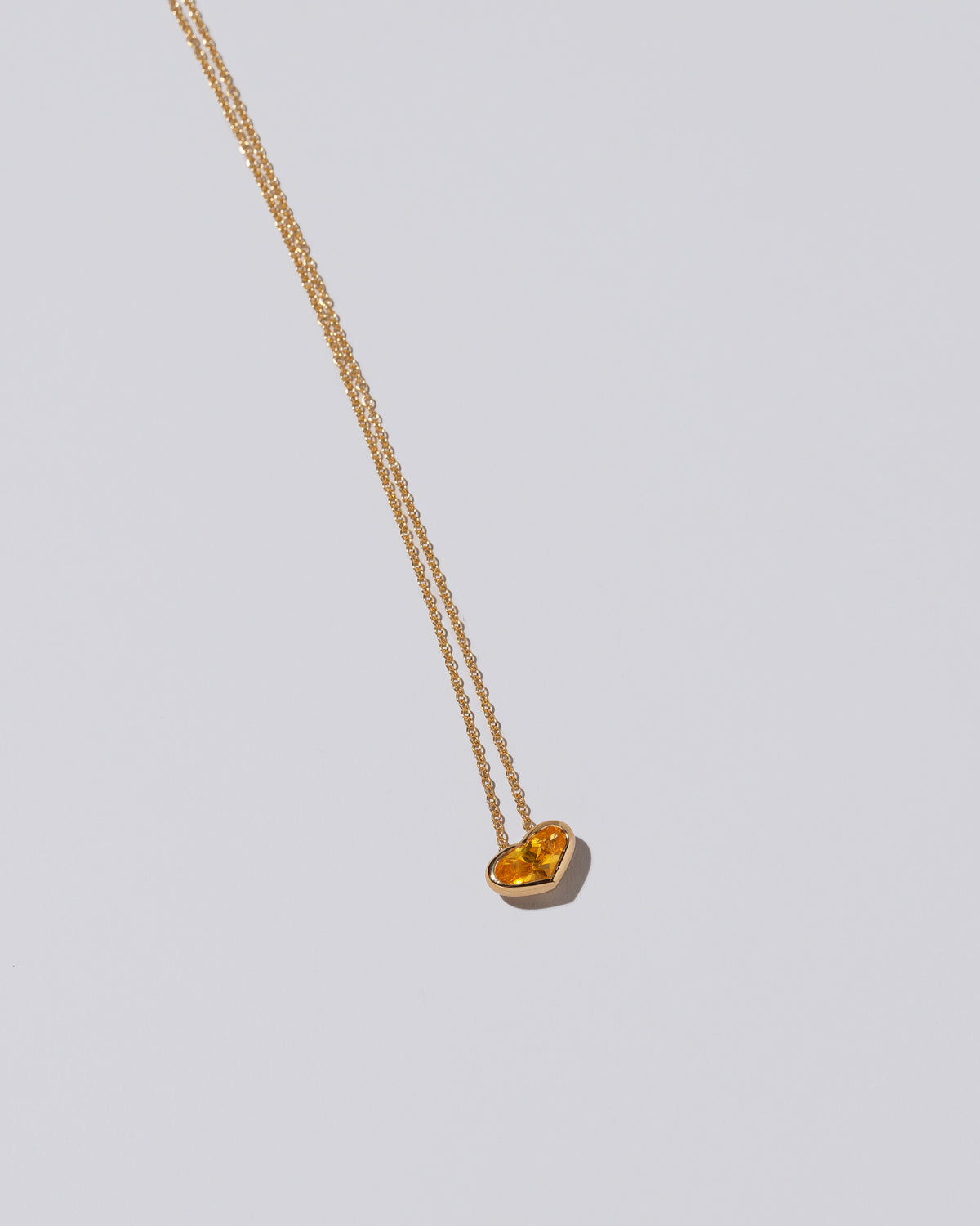 Venus Heart Pendant on light color background.