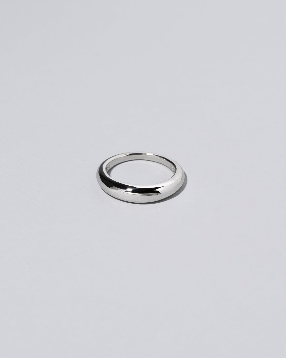 Platinum 4.5mm Venus Band on light color background.