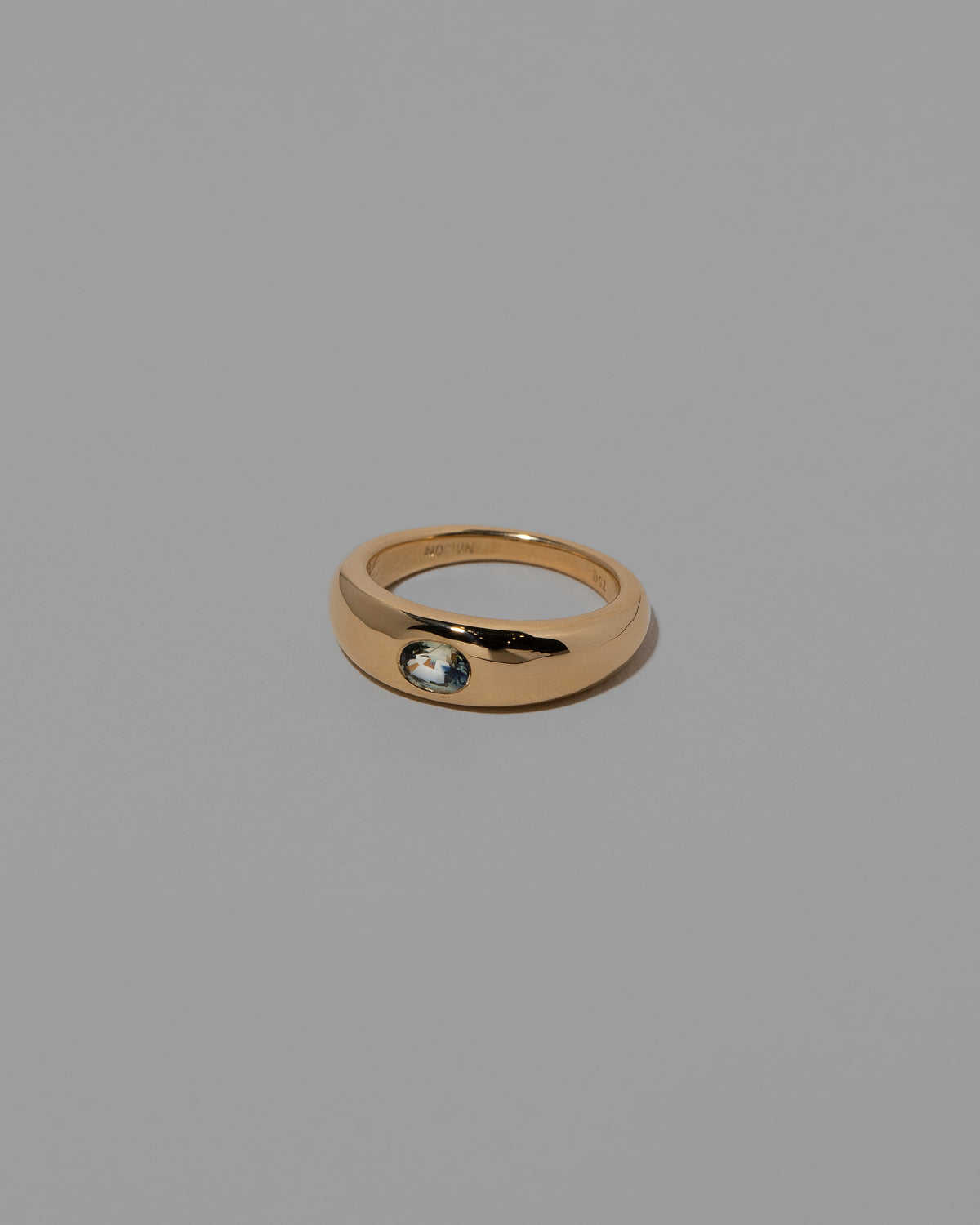 View from the side of the Sapphire Venus Ring on light color background.