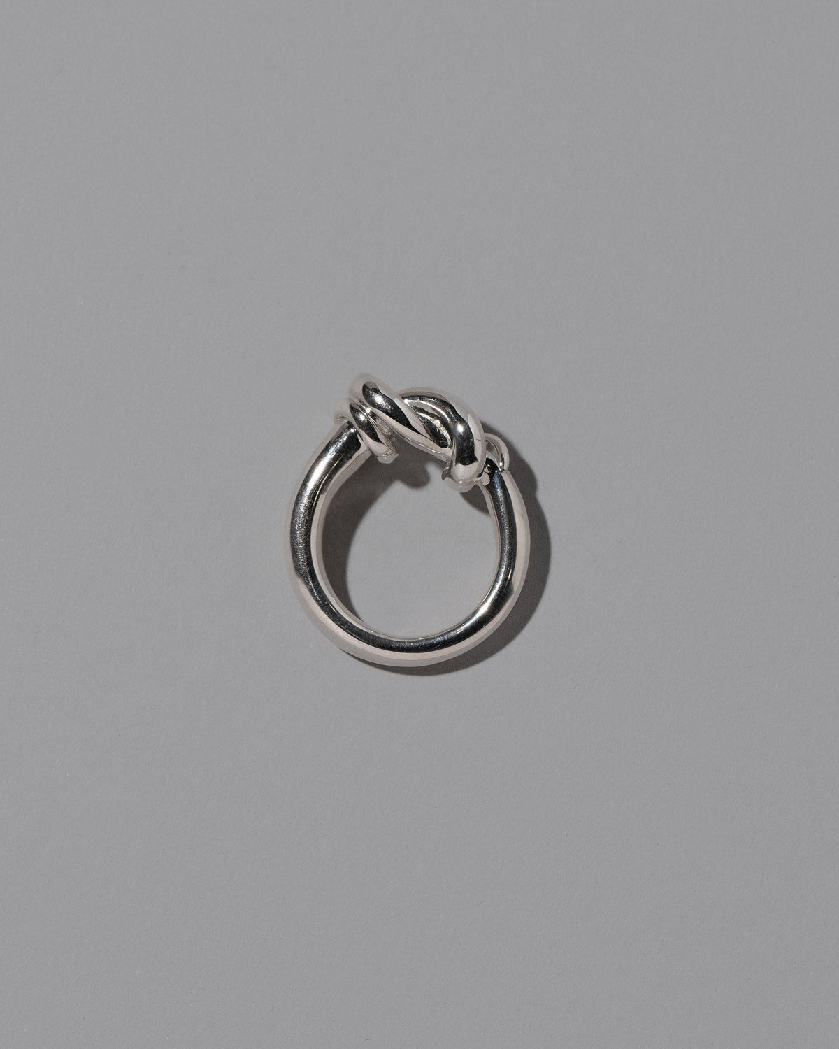 View from the side of the CRZM Sterling Silver Ridge Ring on light color background.