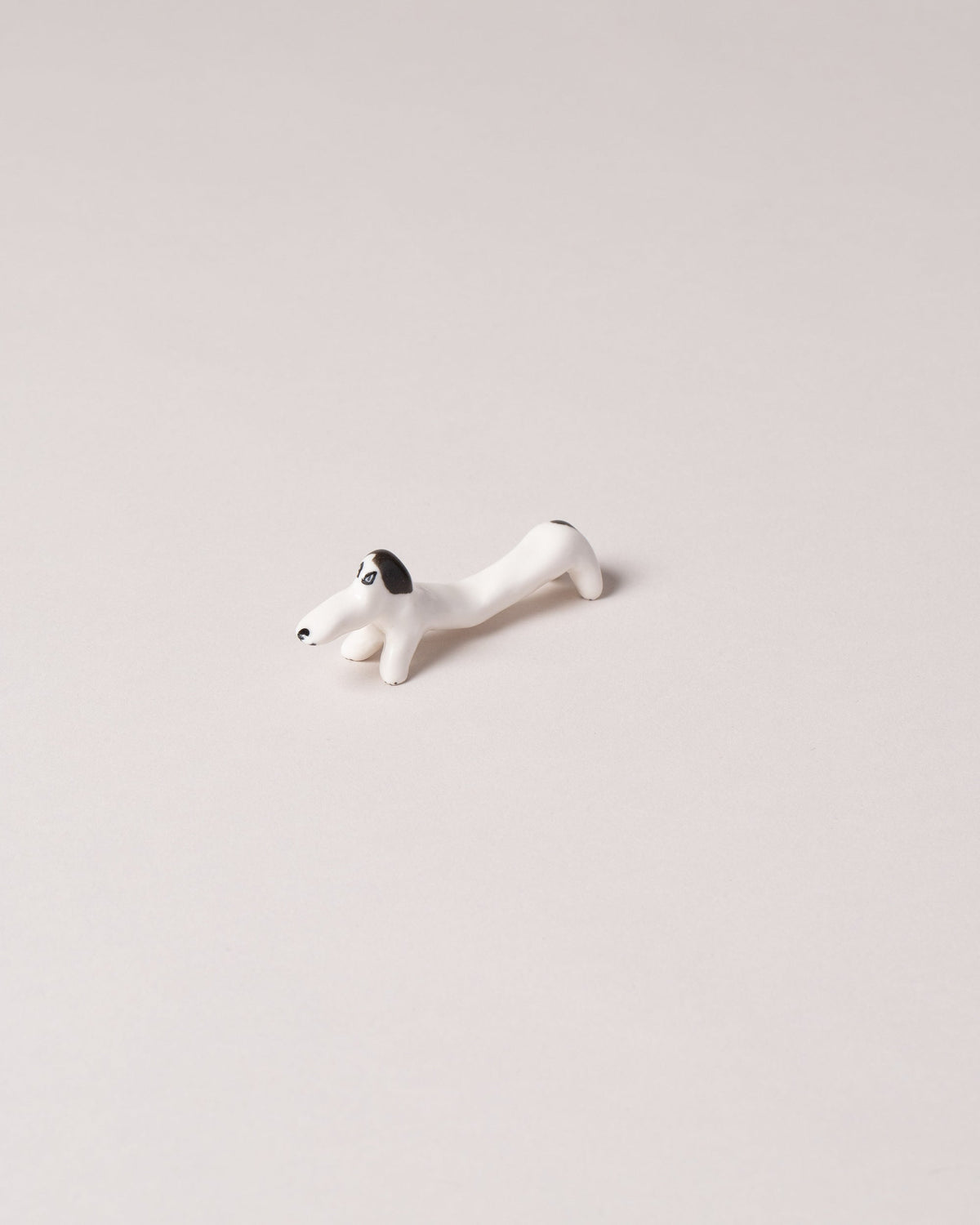 Eleonor Boström Black Chopstick Dog Rest on light color background.