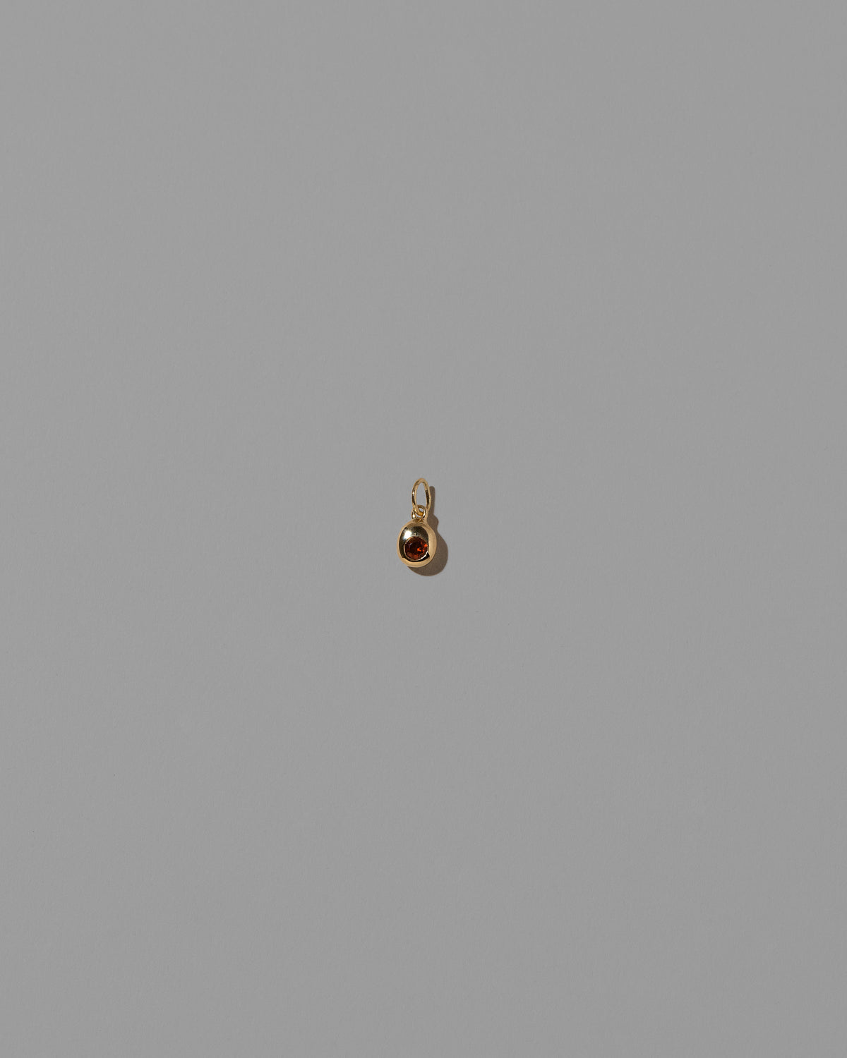 Garnet Birthstone Level Charm on light color background.