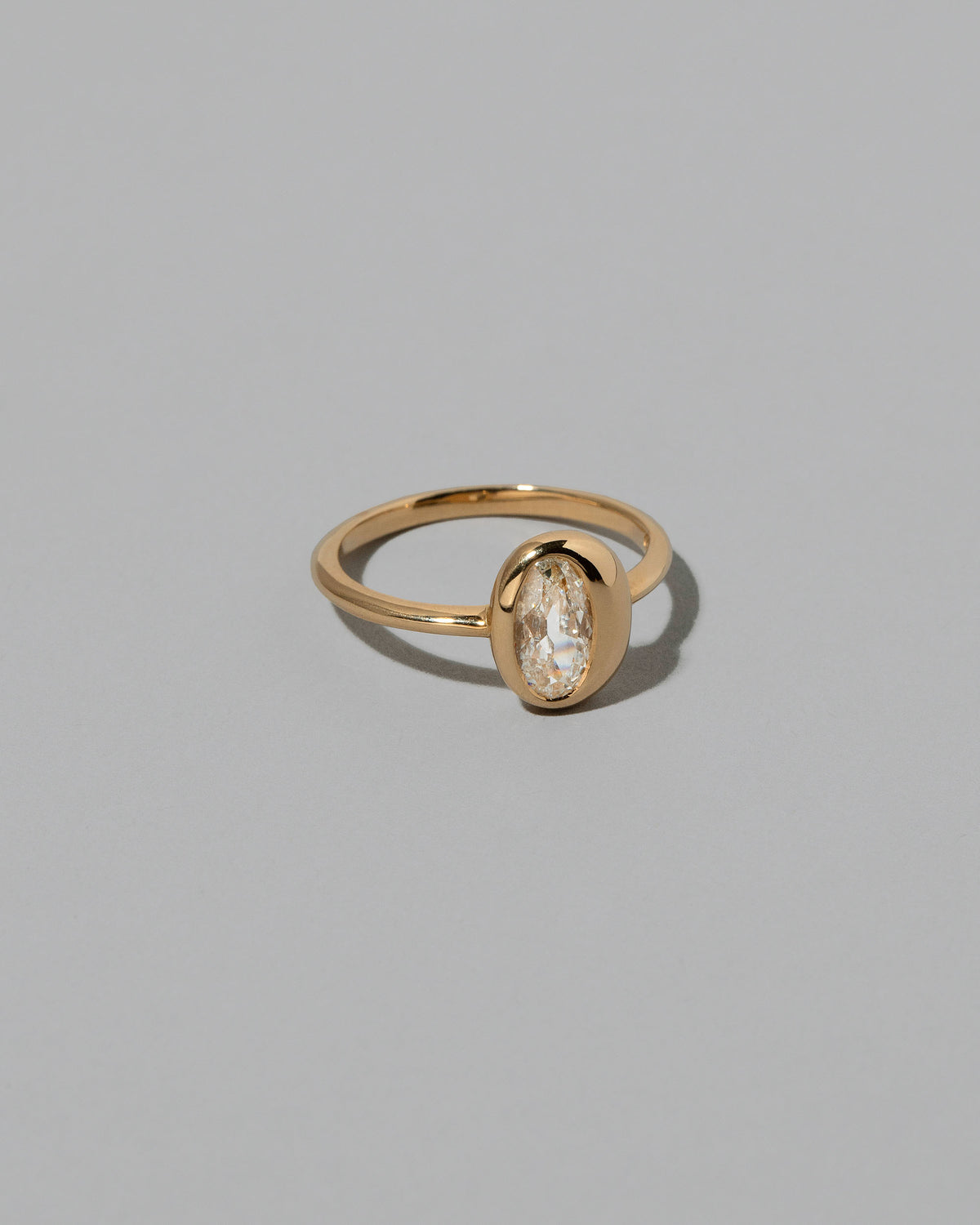 View from the side of the Moval Diamond Precise Ring on light color background.