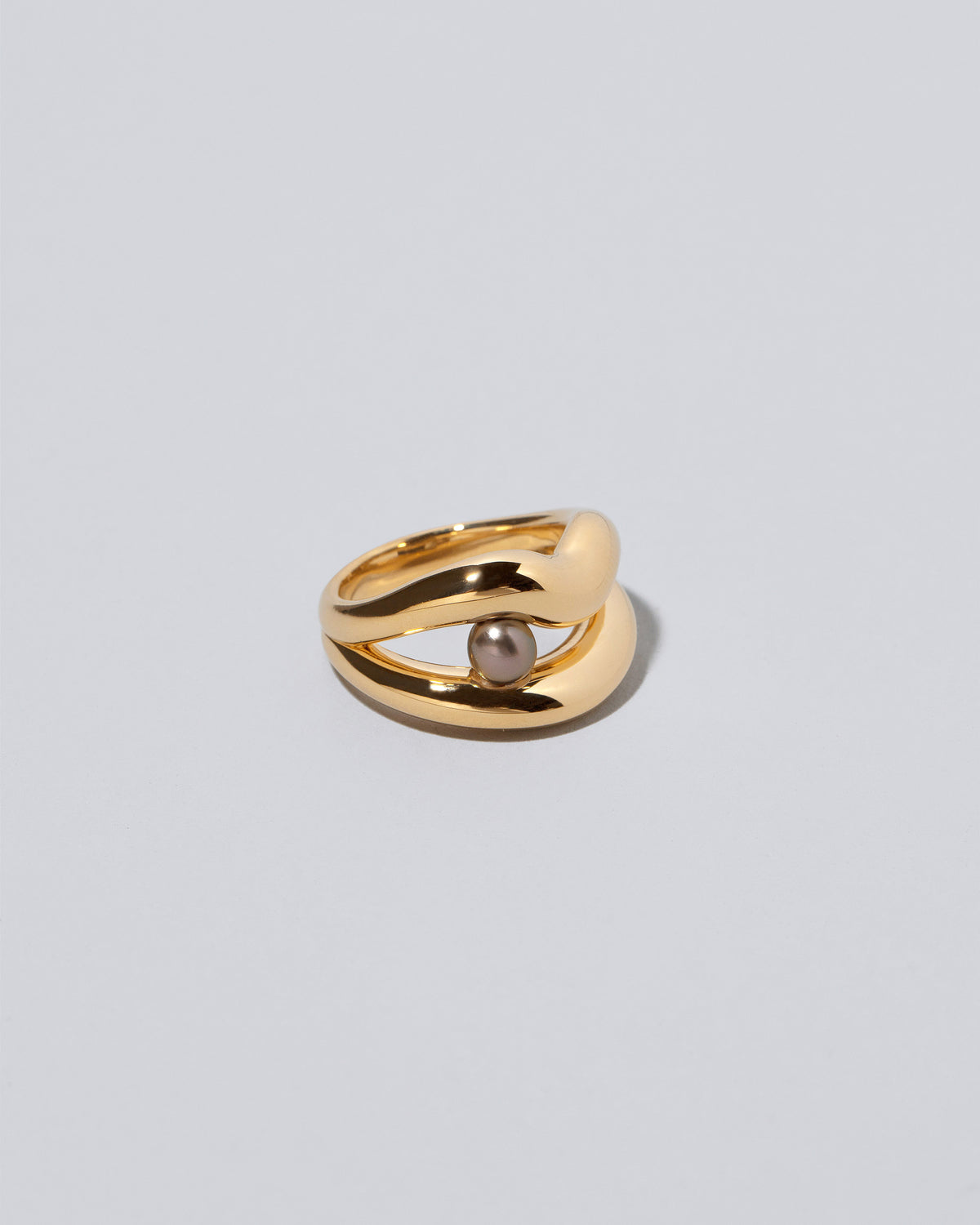 Closeup details of the Ocean of Unity Ring on light color background.