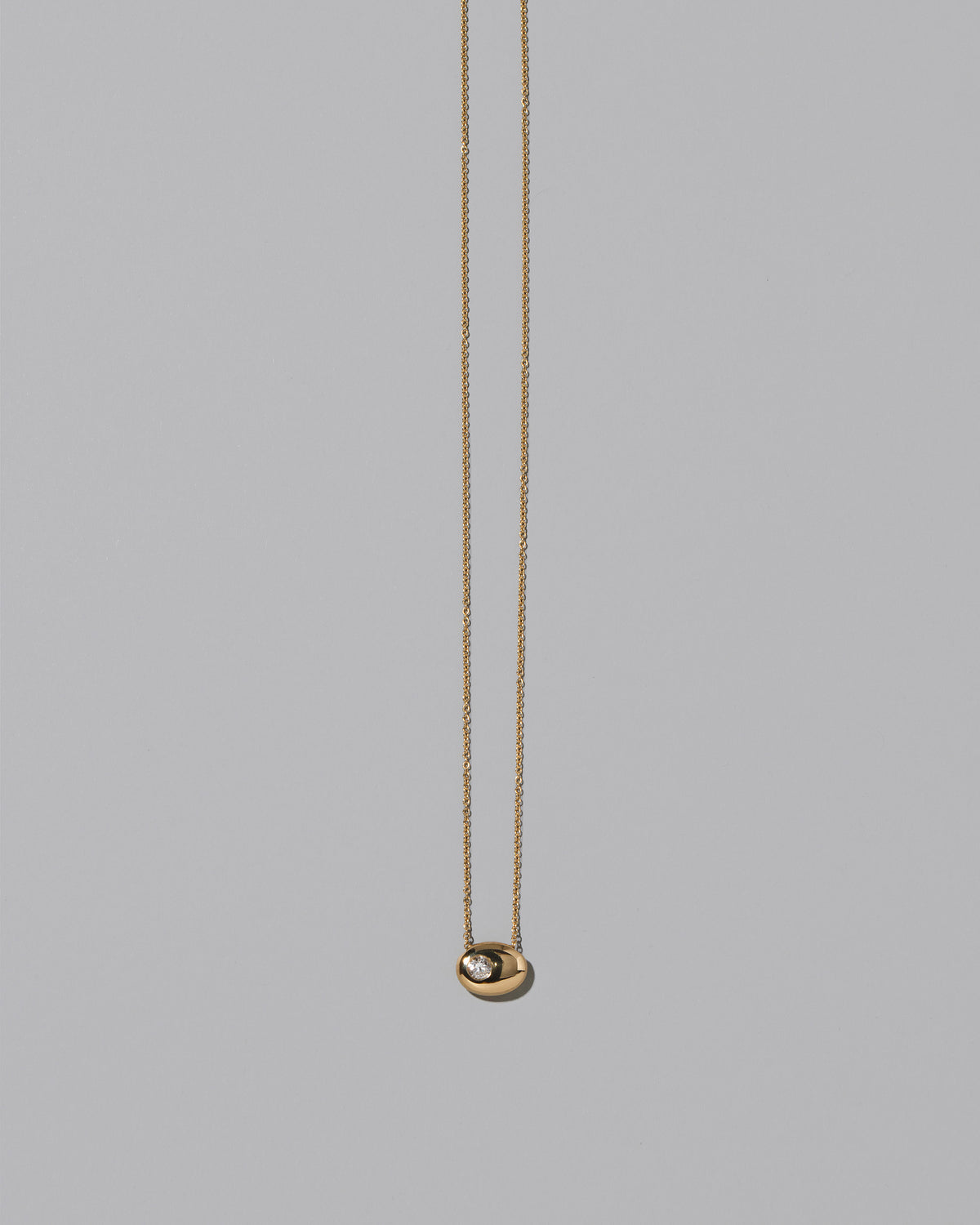Gold Diamond Level Necklace on light color background.