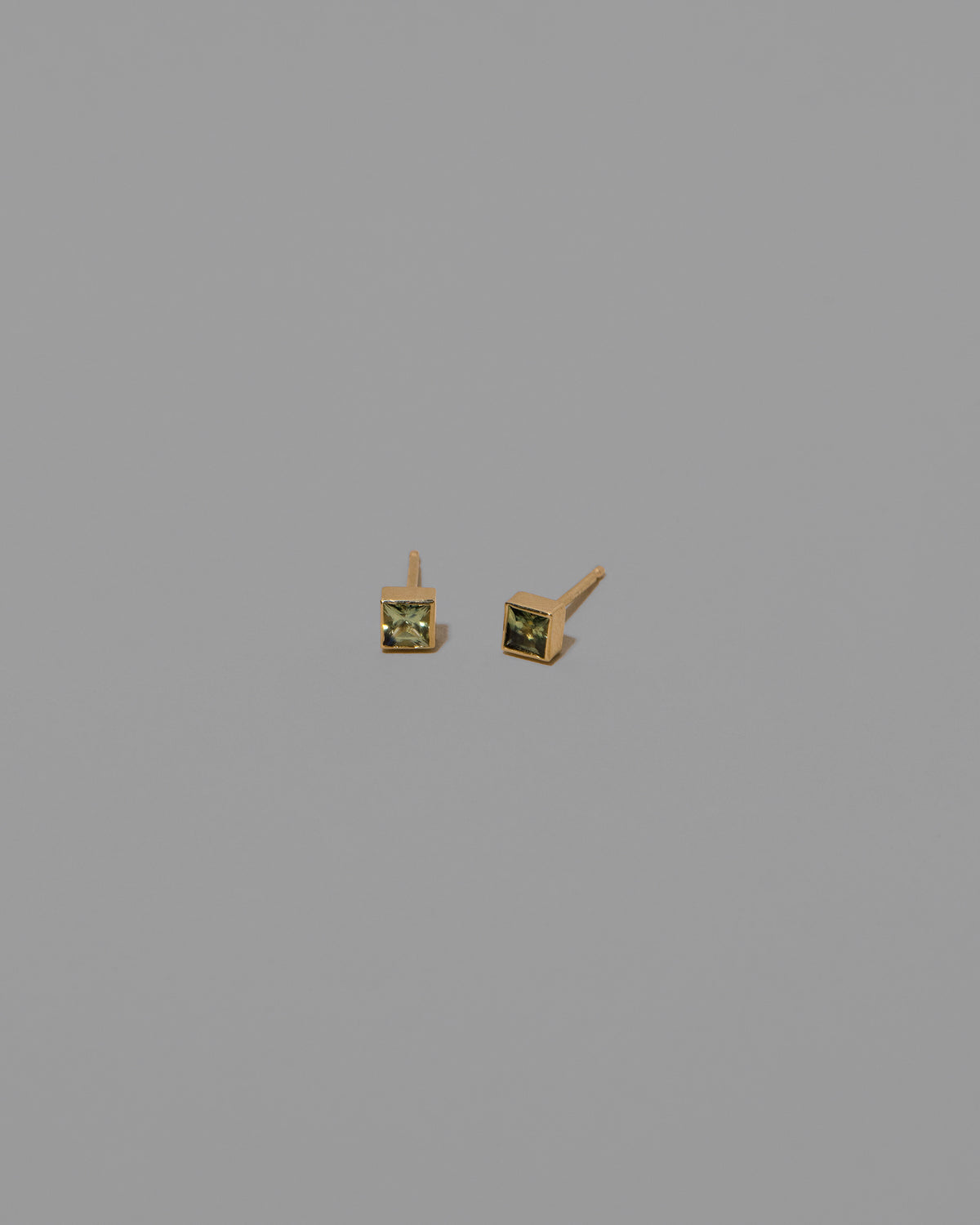 Petite Bicolor Green Sapphire Square Frame Stud Earrings on light color background.