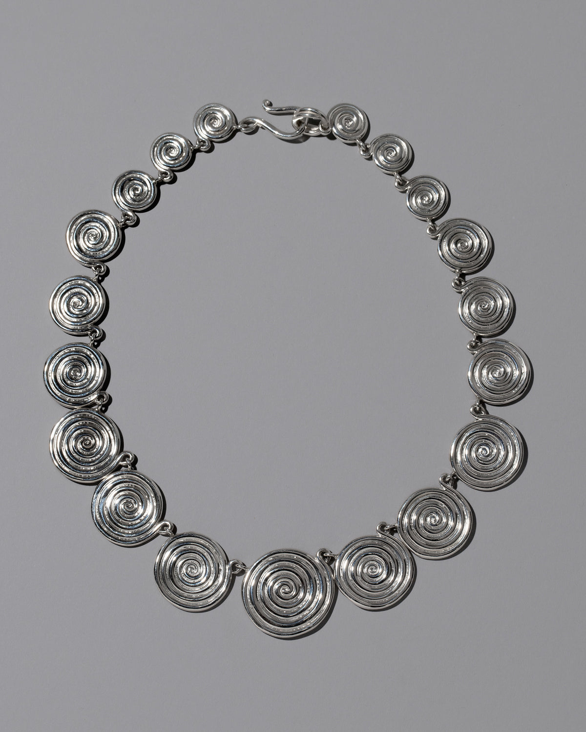 CRZM Sterling Silver Serpentinite Necklace on light color background.