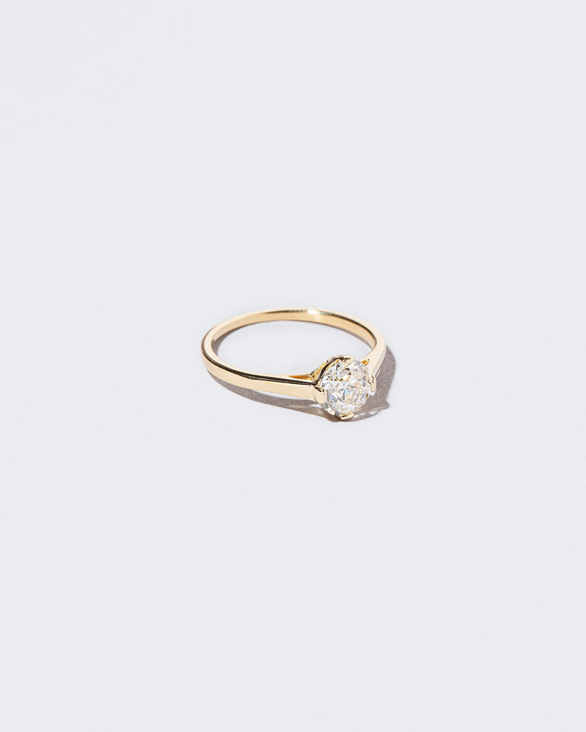View from the side of the White Diamond Barragán Ring on light color background.