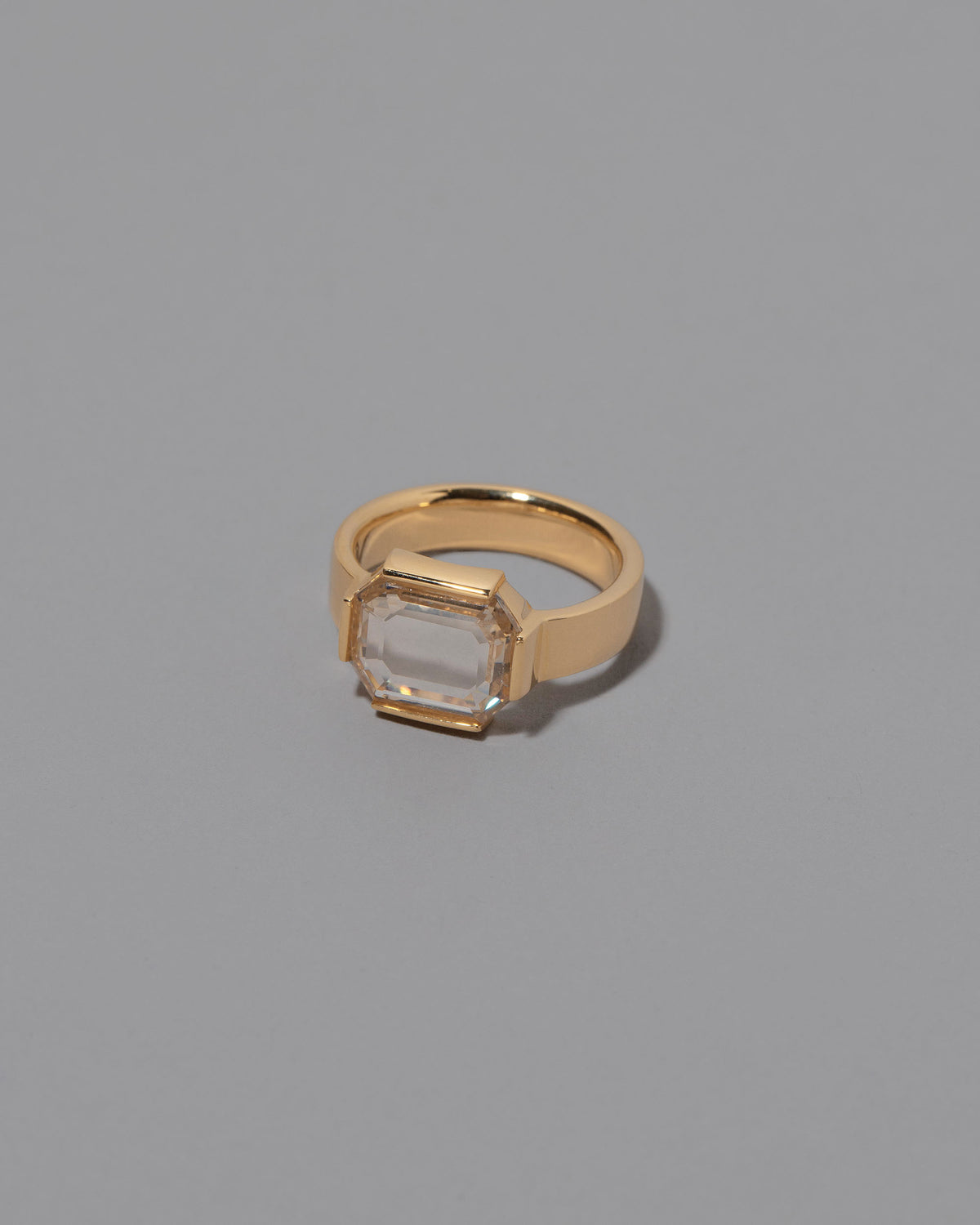 View from the side of the Envelop Ring on grey color background.