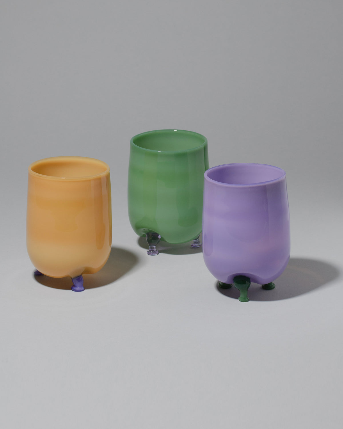 Group of Ornamental by Lameice Mint & Lilac, Violet & Mint and Topaz & Violet Opaque Eye Candy Cocktail Glasses on light color background.