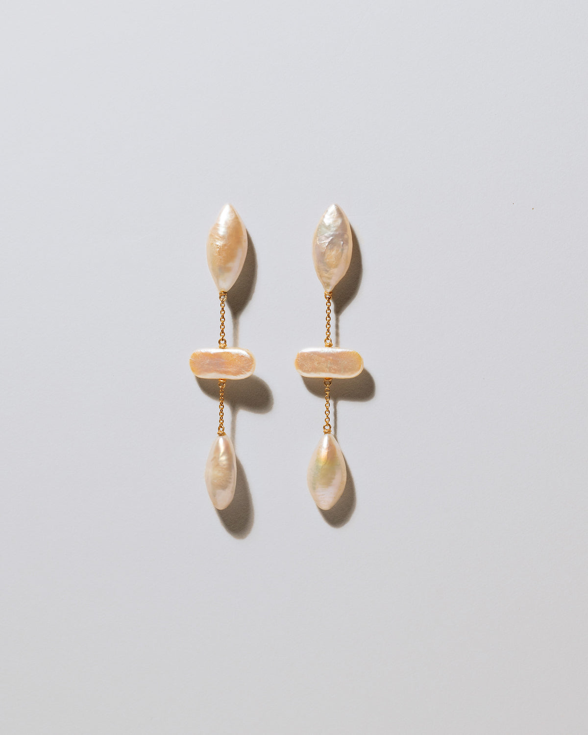 Osprey Pearl Earrings on light color background.