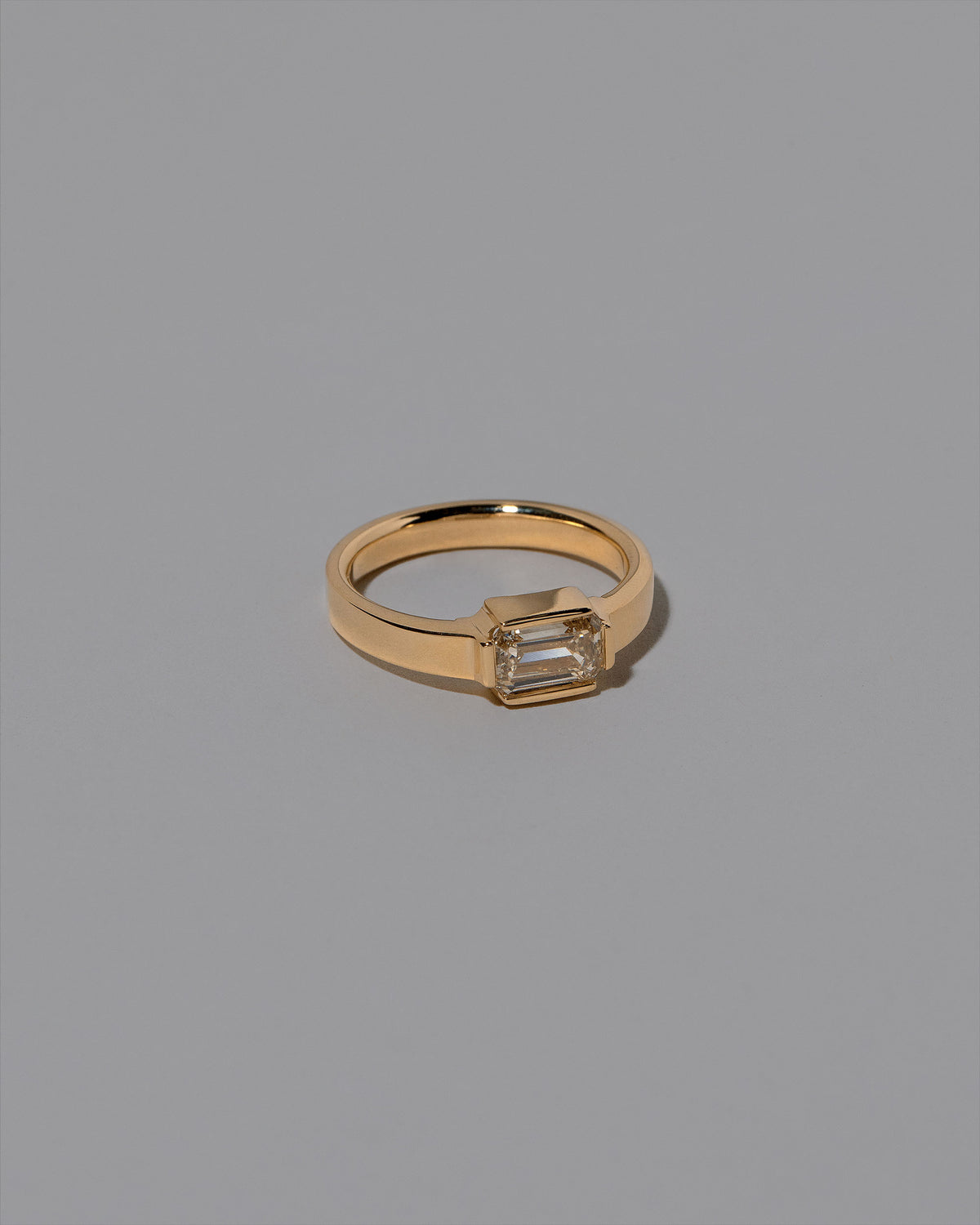 View from the side of the Champagne Diamond Fold Ring on light color background.