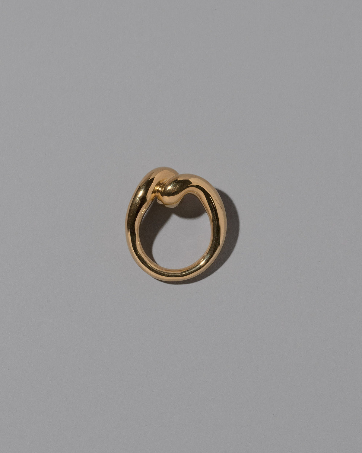 View from the side of the CRZM Gold Landform Ring on light color background.