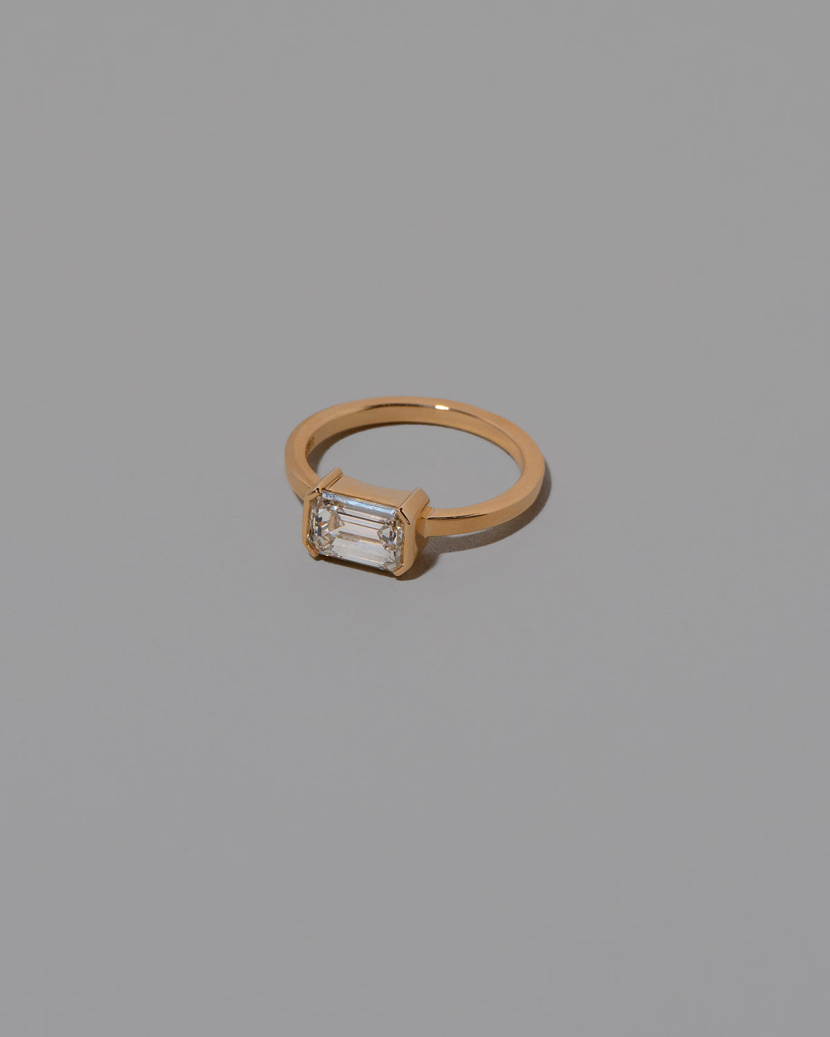 View from the side of the Diamond Courtship Ring on light color background.