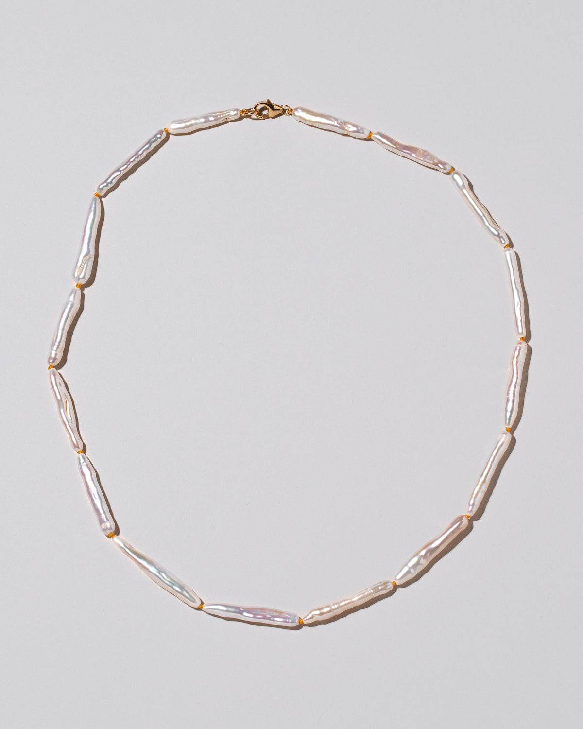 Stick Pearl Strand Necklace on light color background.