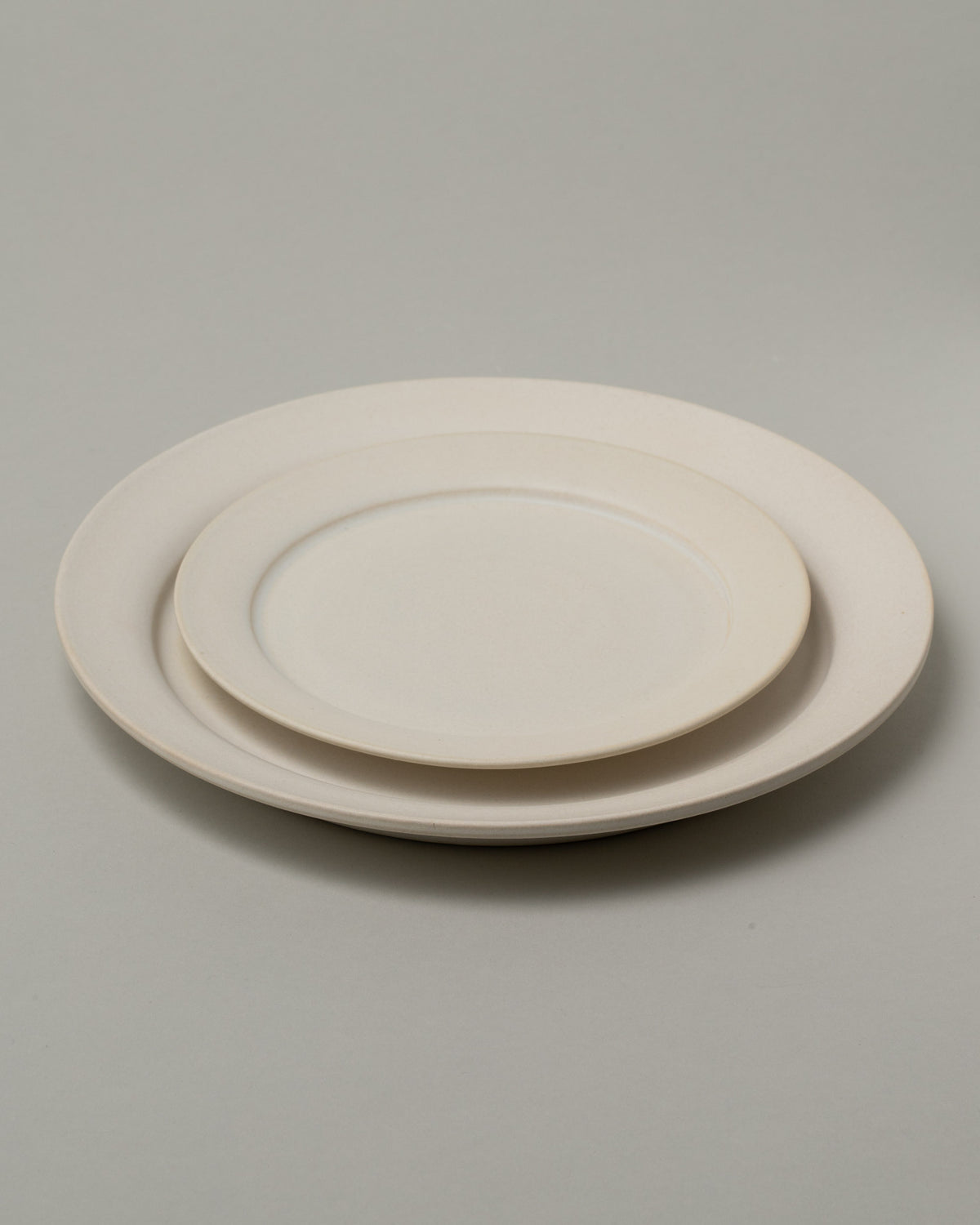 Tracie Hervy Dinner Plate and Salad Plate on light color background.