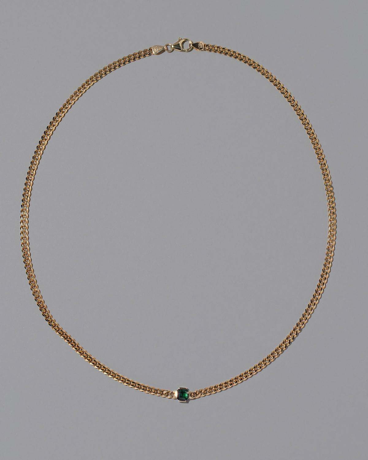 Emerald Fold Necklace on light color background.