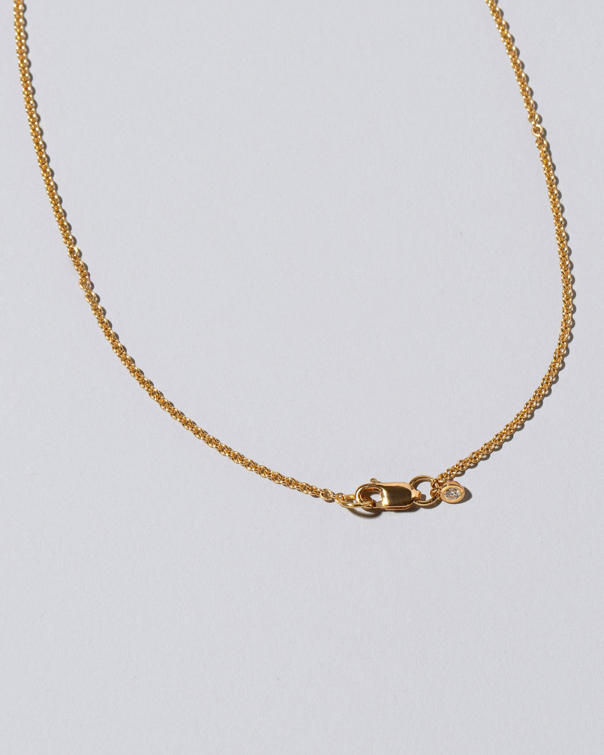 View from the back of the Adamas Necklace on light color background.