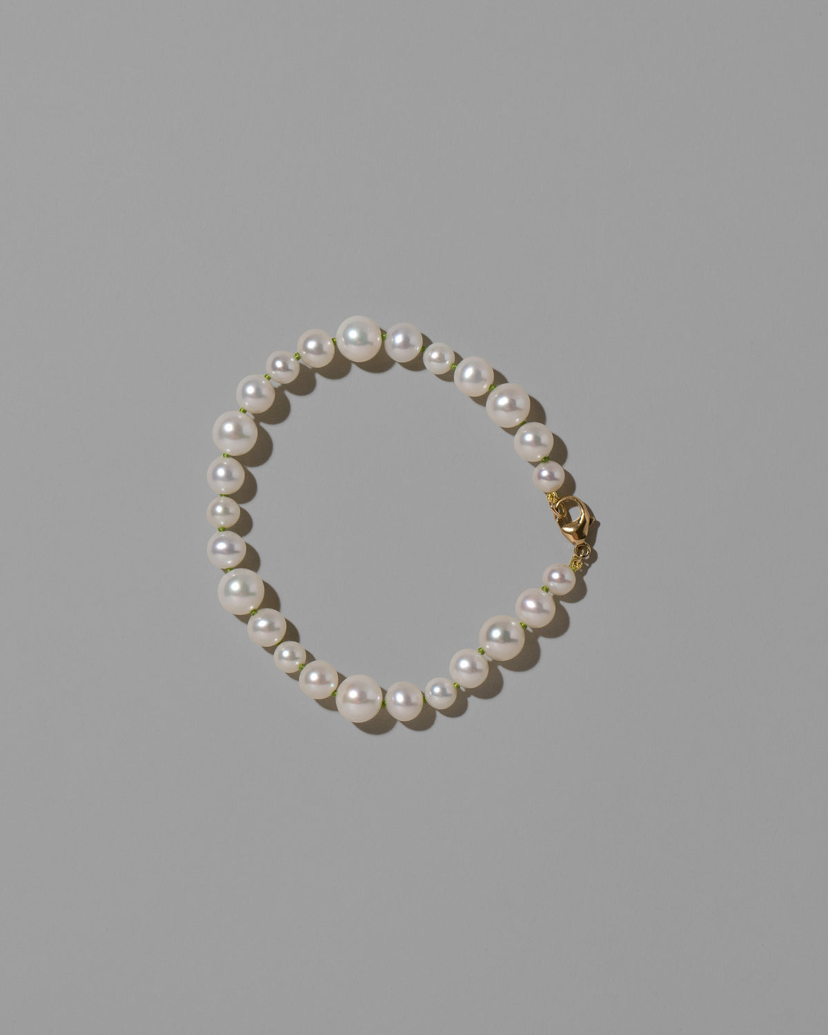 Grass Green Thread Bubble Pearl Bracelet on light color background.