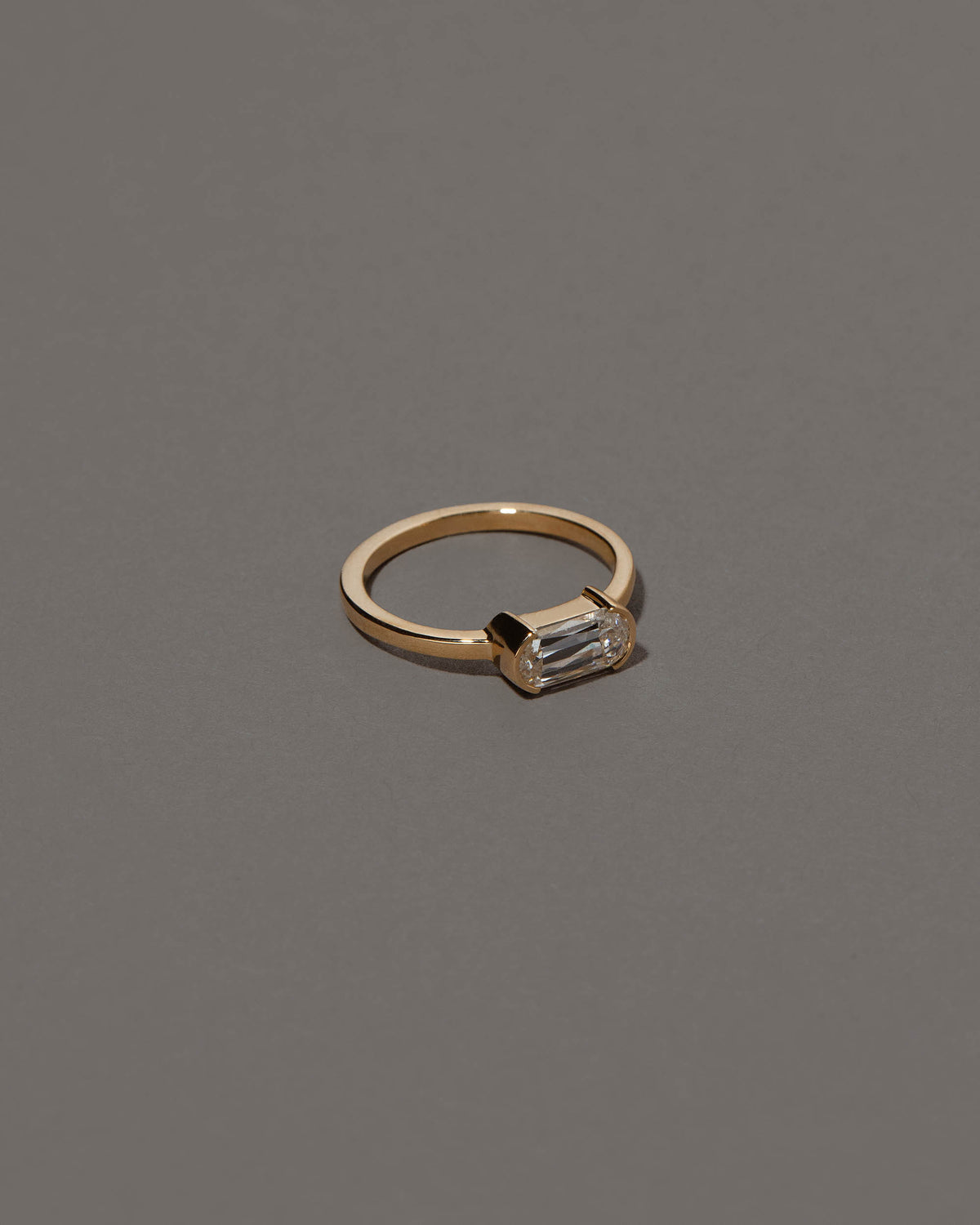 View from the side of the Conviviality Ring on grey color background.