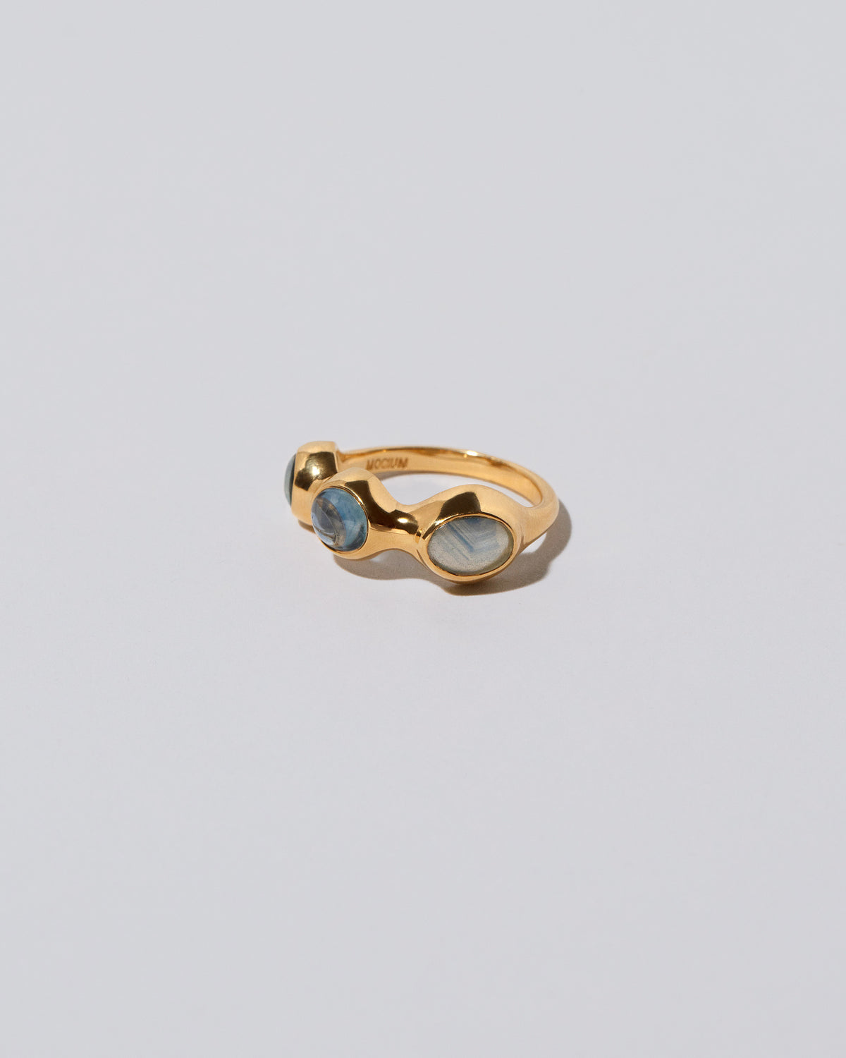 View from the side of the Sword Swallower Ring on light color background.