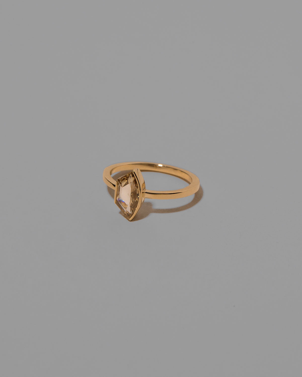 View from the side of the Adulation Ring on light color background.