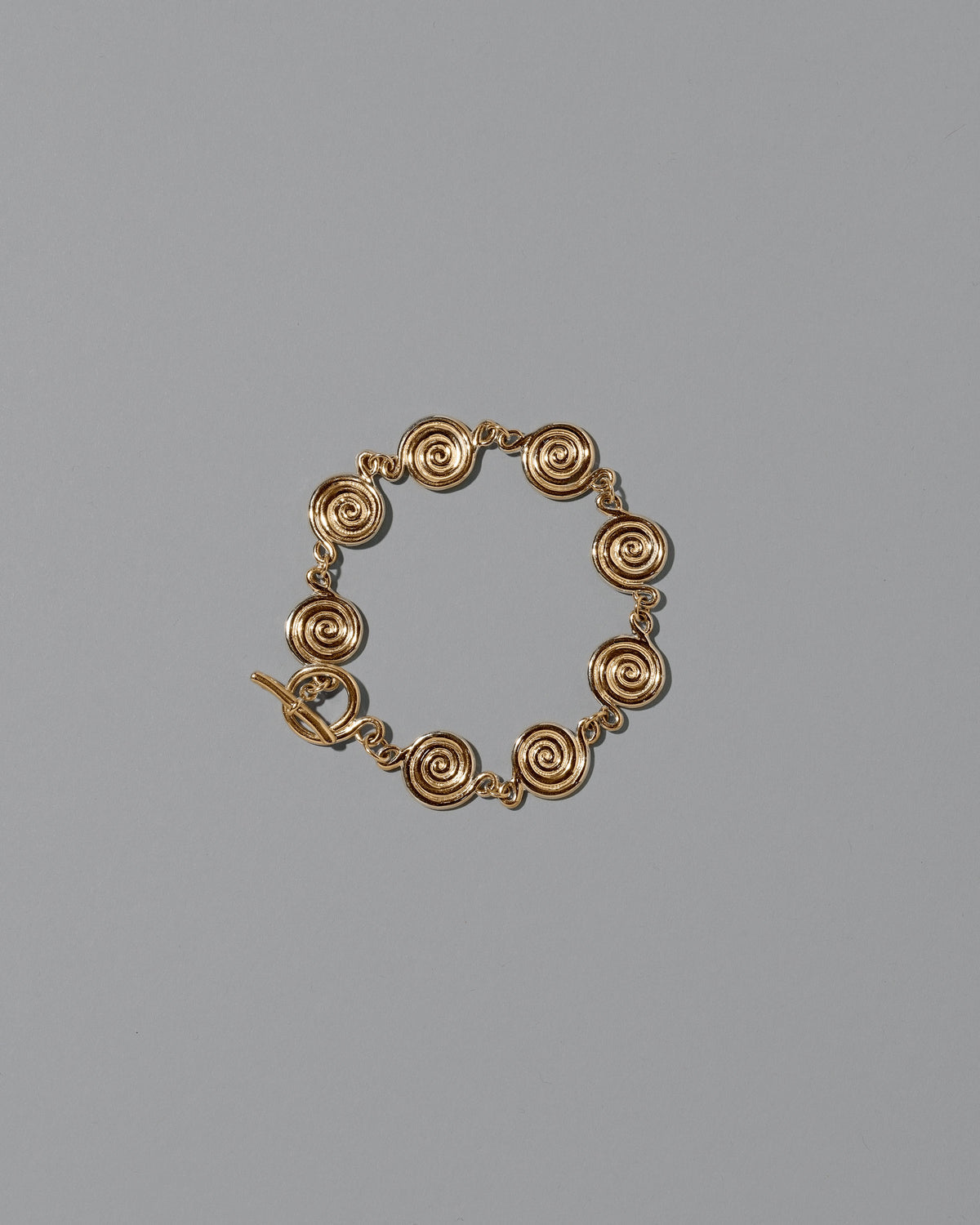 CRZM Gold Serpentinite Bracelet on light color background.