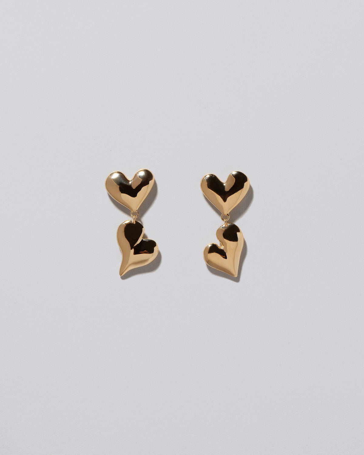 Thousand & One Night Heart Drop Earrings on light color background.
