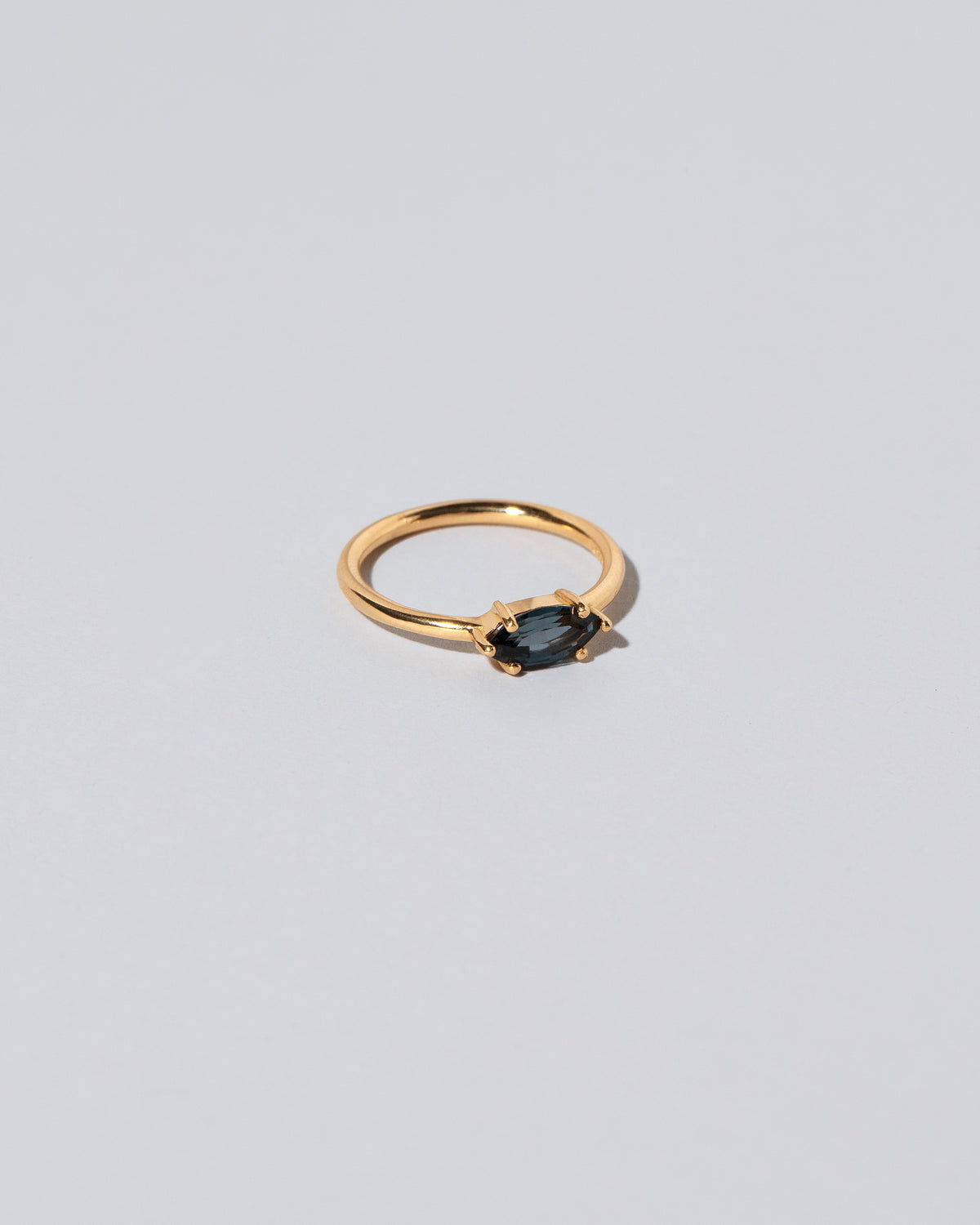 View from the side of the Deep Blue Ouvert Ring on light color background.