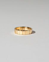 Yellow Gold 6mm Etched Lines Band on light color background.