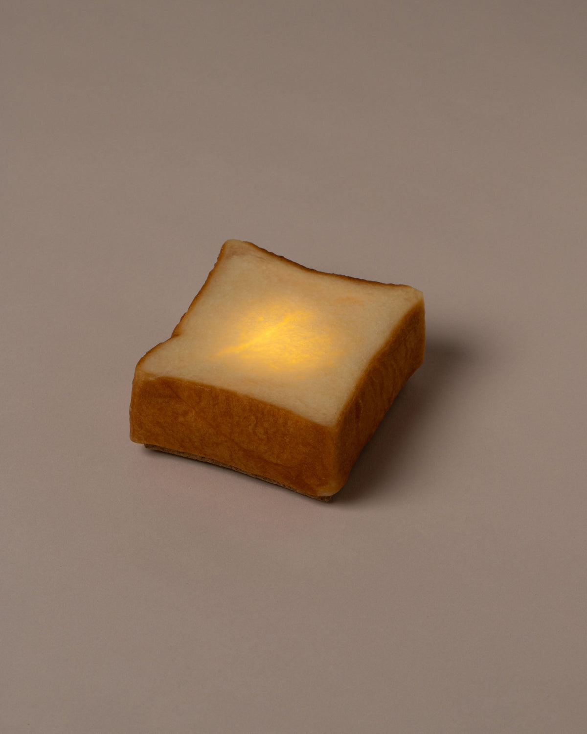 Pampshade lit Style A Toast Lamp on light color background.