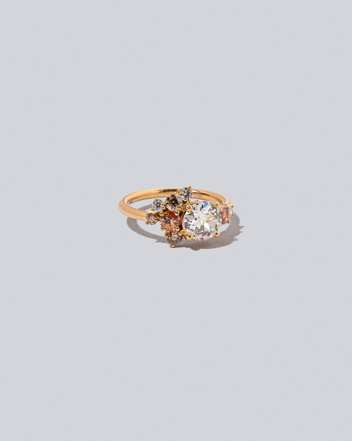 Product photo of the Peach Vega Ring on a light color background. 
