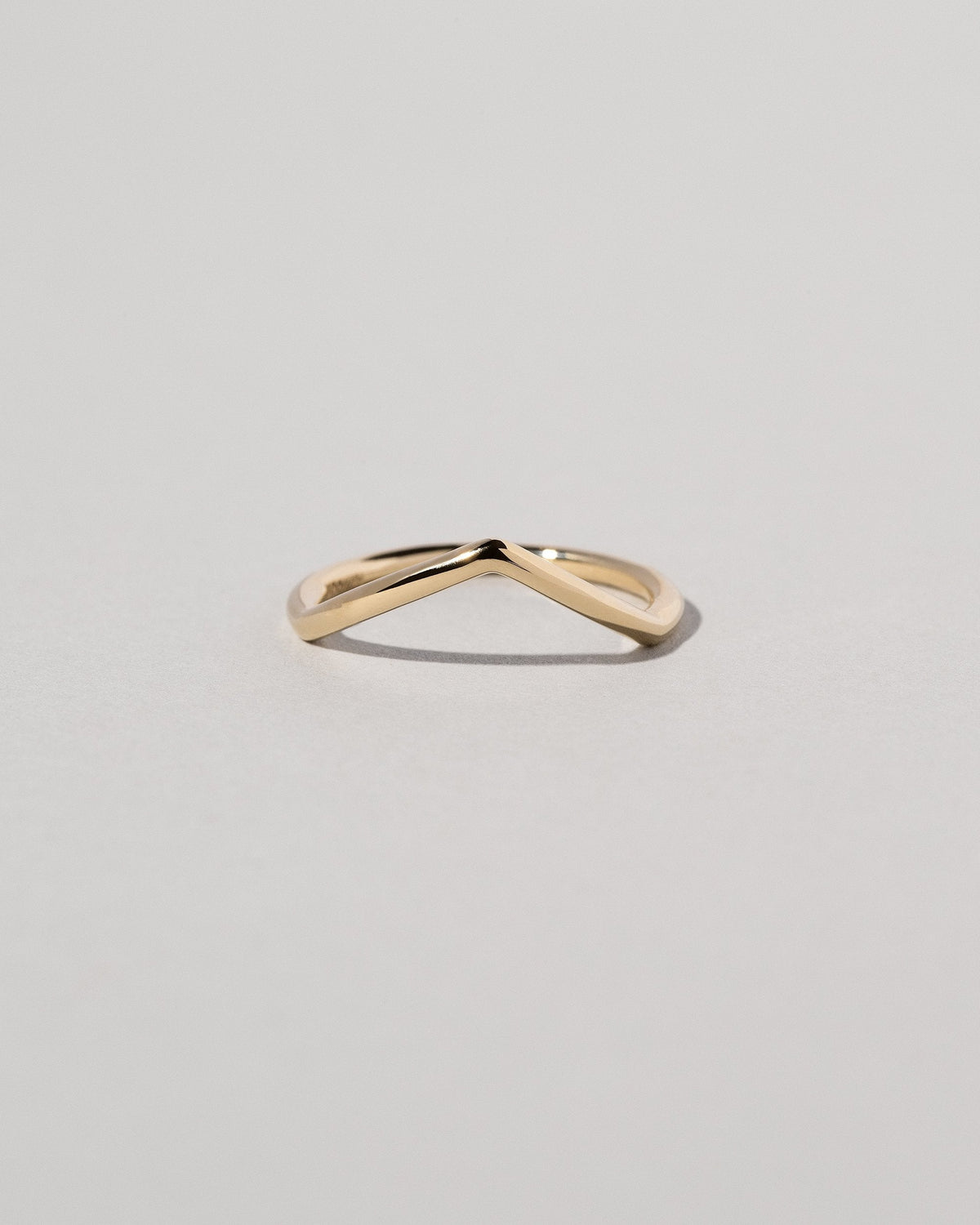 Gold Solid Round Wire Luna Peak Band on light color background.