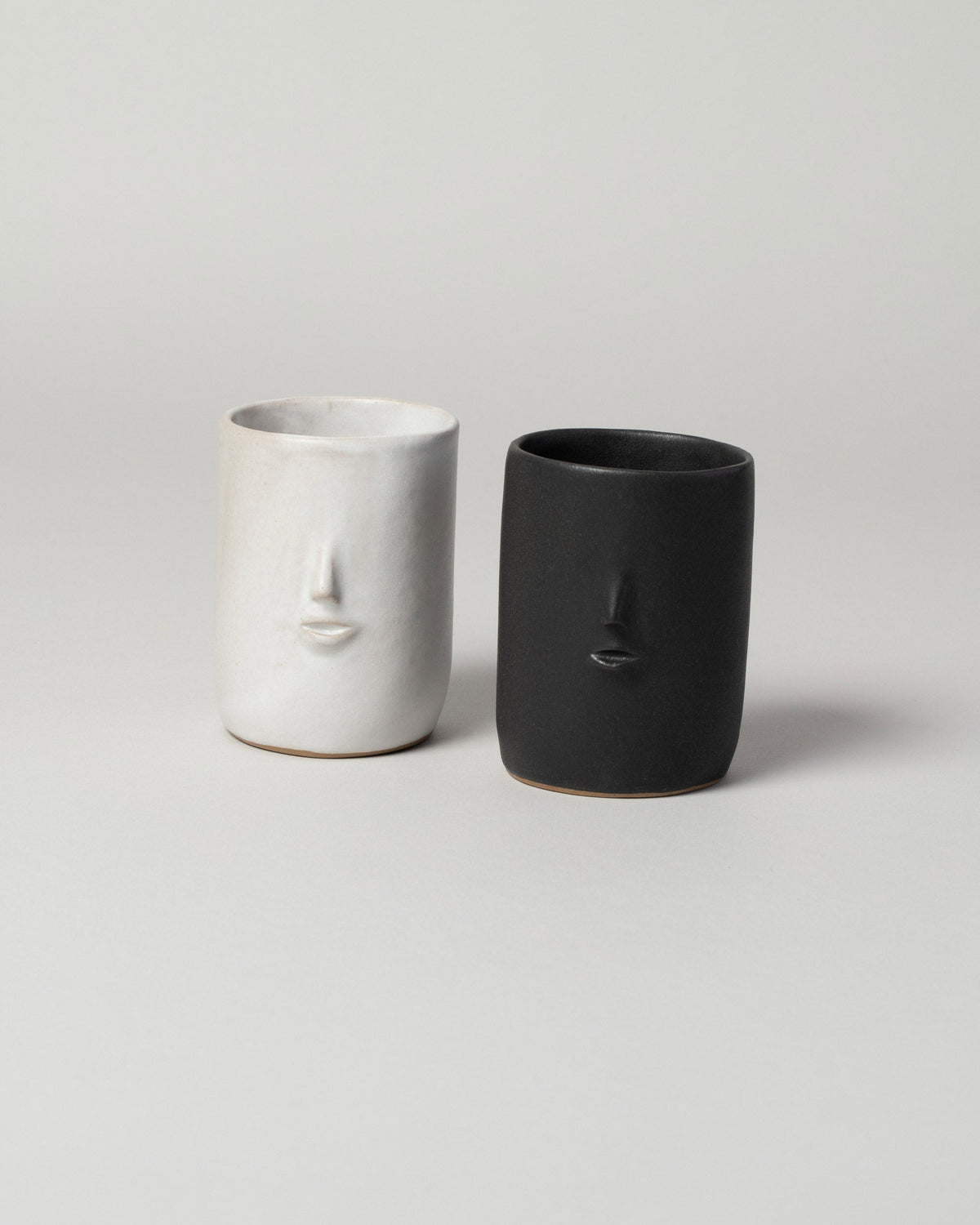 Group of  Rami Kim Mini Face Tumbler on light color background.