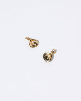  Clams Casino Charm on light color background.