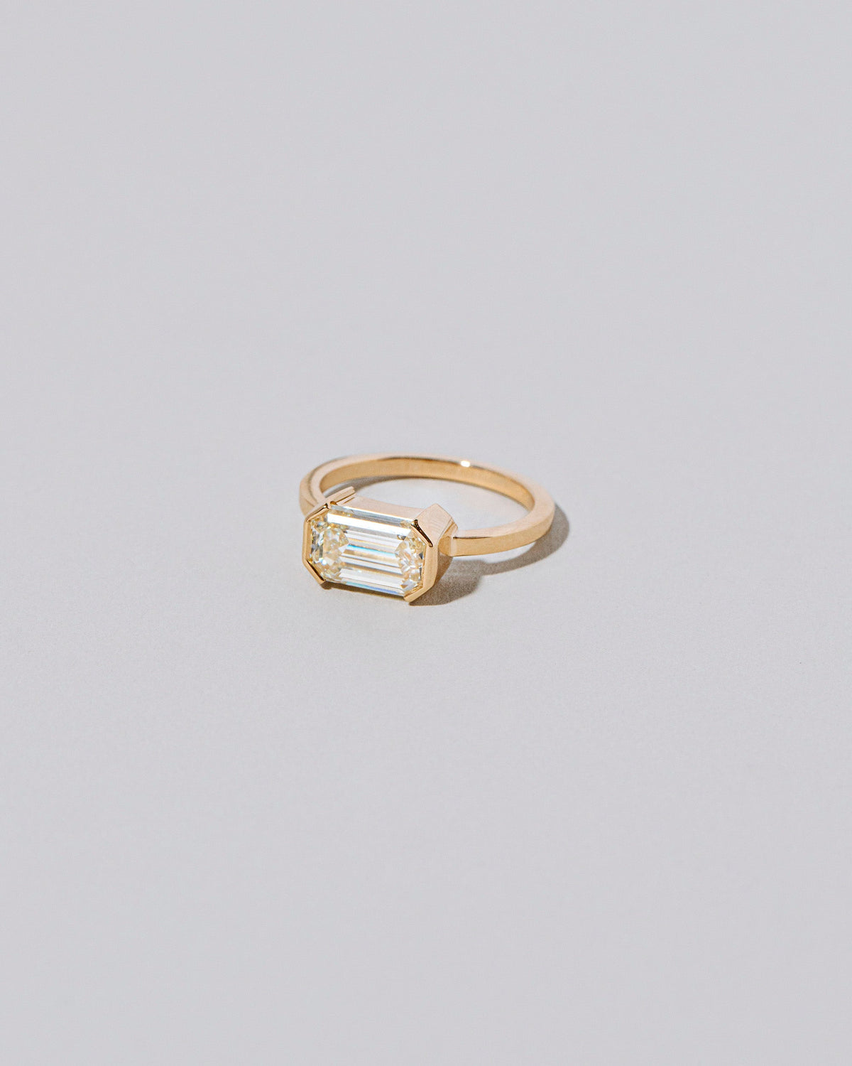 View from the side of the Two of Hearts Ring on light color background.