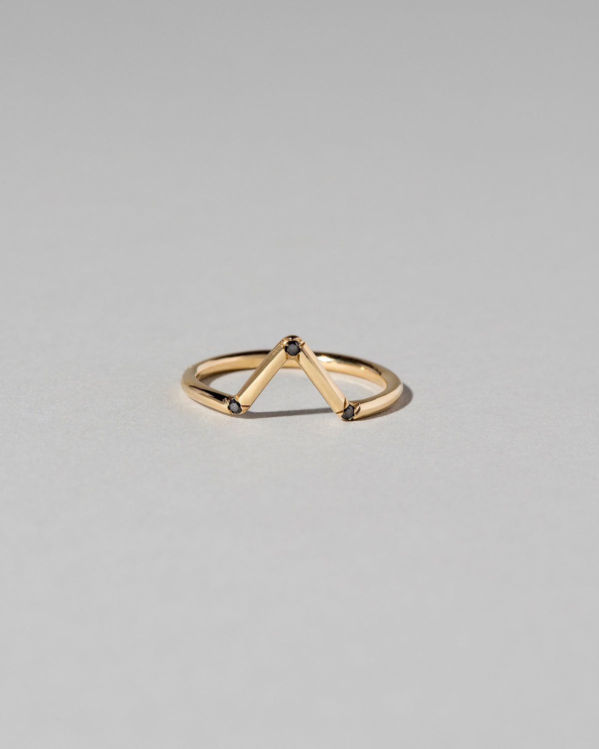 Gold Black Diamond Three Stone Triangle Band on light color background.