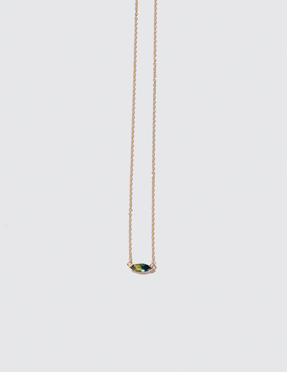Product photo of Fin Necklace on a light color background 