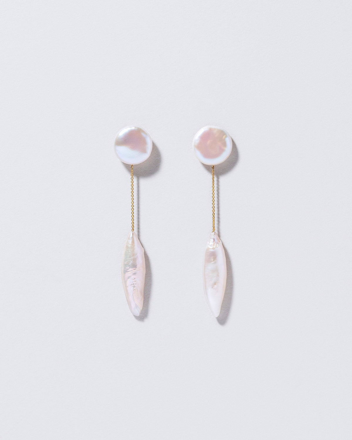 Triton Earrings on light color background.