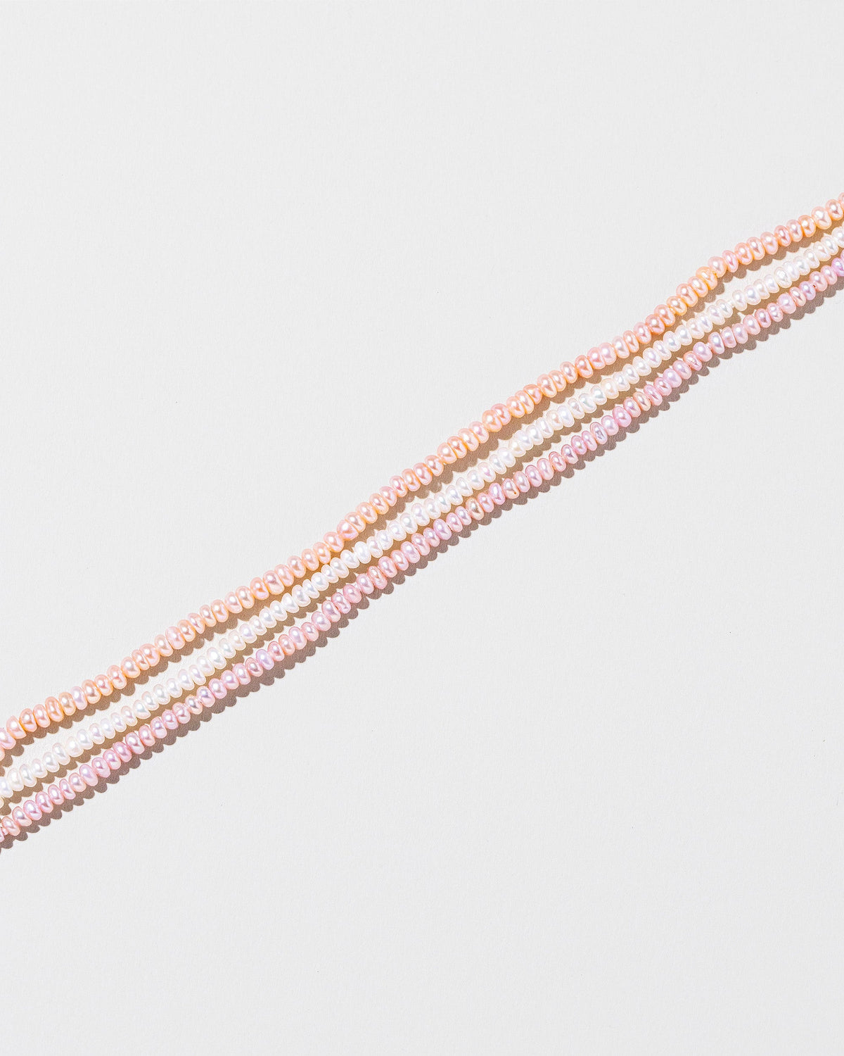  Multi Strand Seed Pearl Choker on light color background.