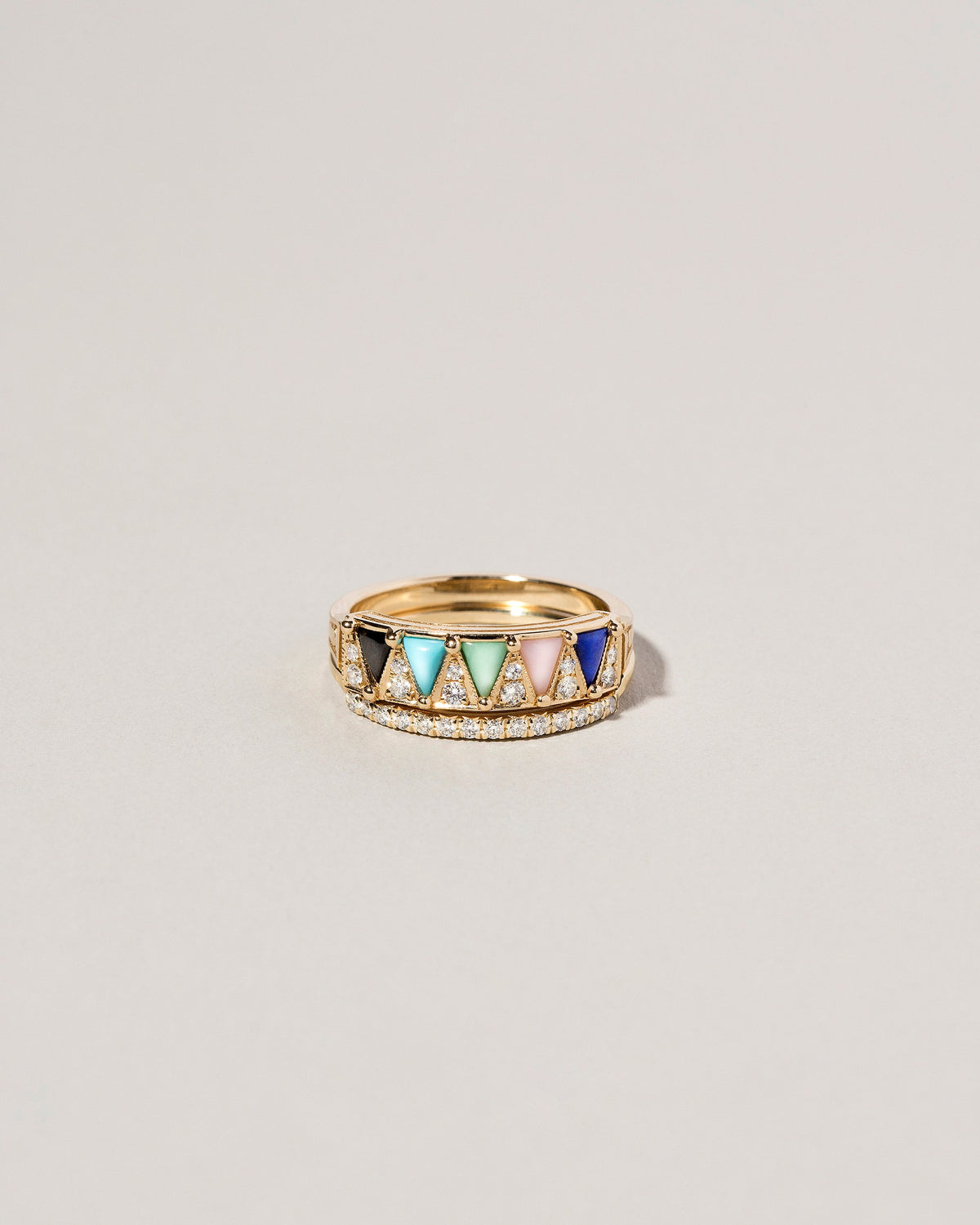 Gold Mega Five Triangle Ring and Gold Notched Band on light color background.