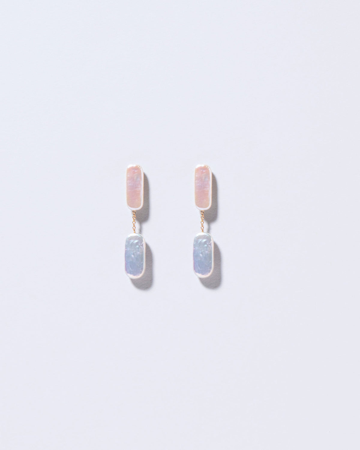  Neleus Earrings on light color background.