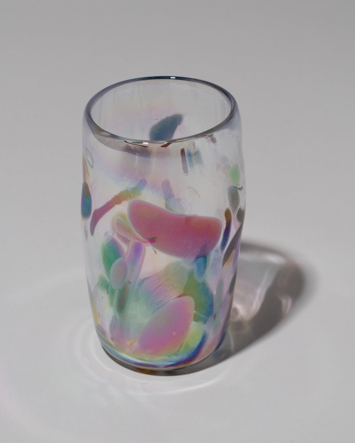 Closeup detail of the Sirius Glassworks Iridescent Nassau Tumbler on light color background.